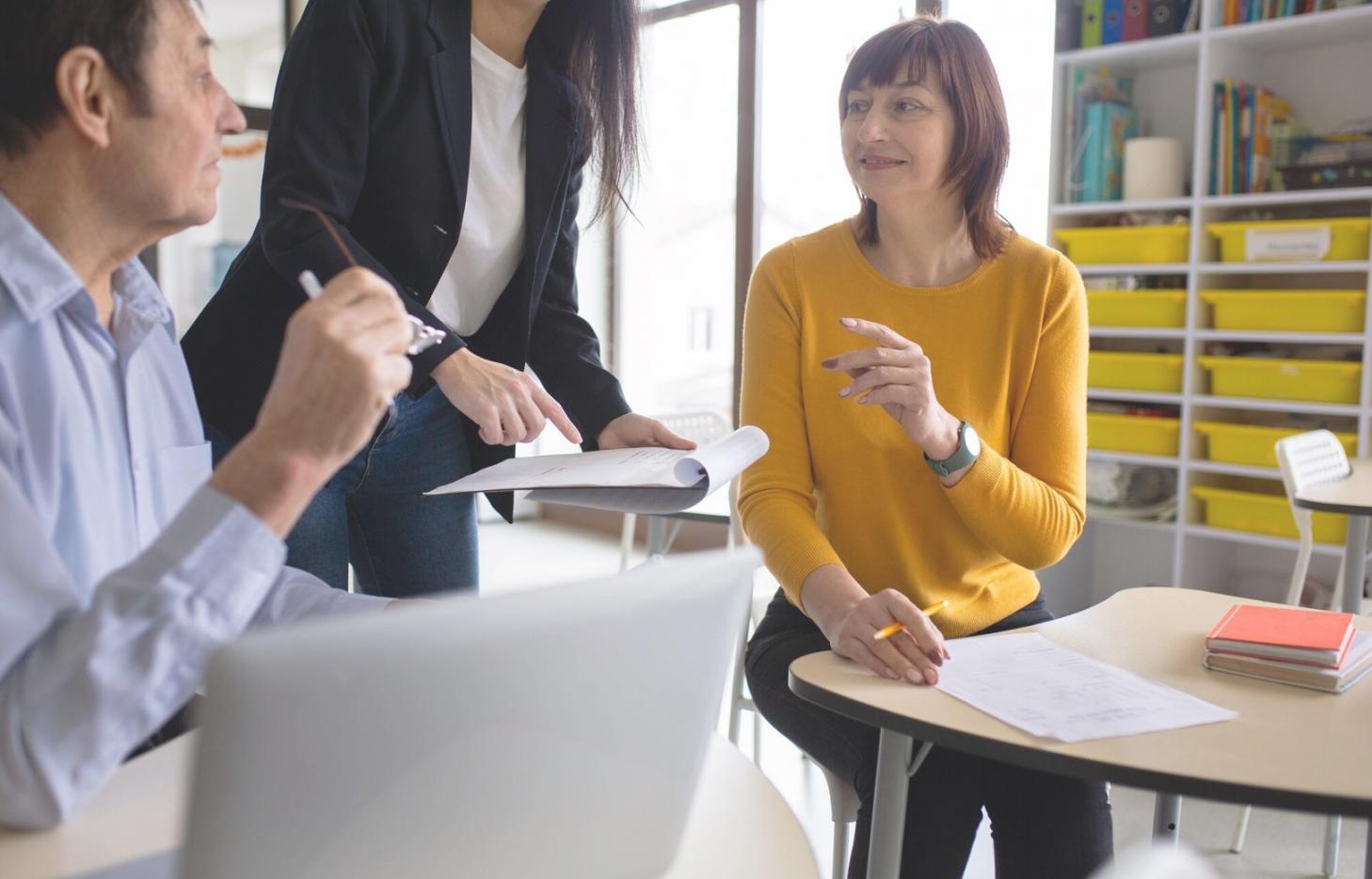 Professional software testing workspace showing multiple monitors with test case documentation and execution interfaces